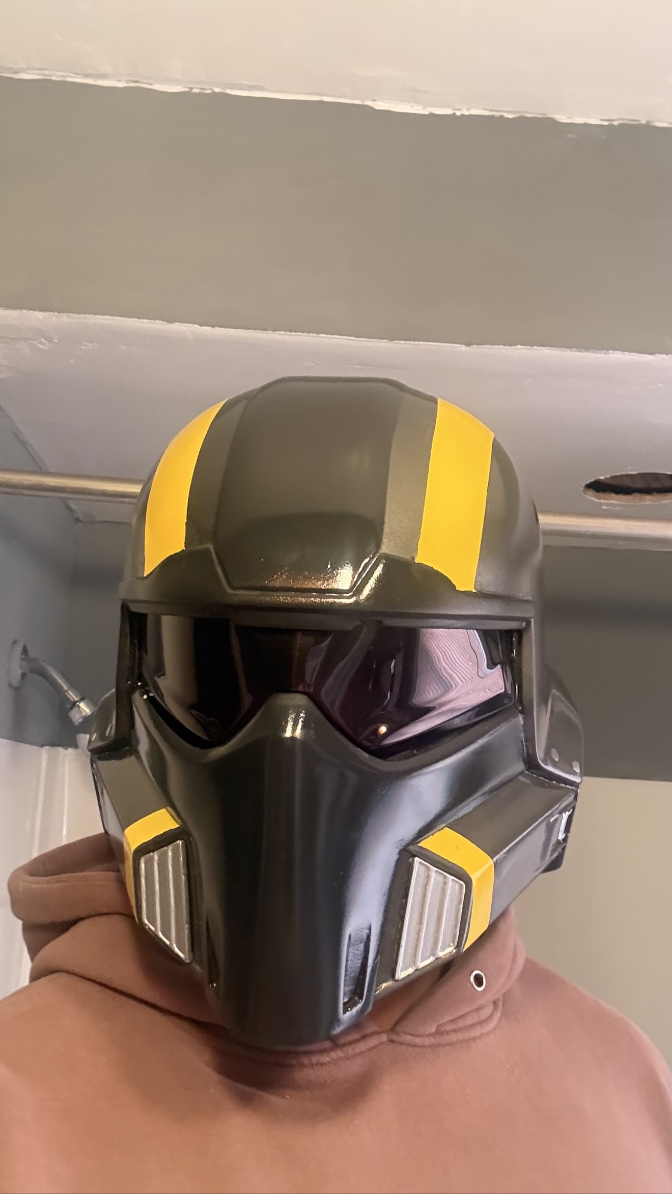 Black Helldiver helmet with yellow stripes and a dark visor